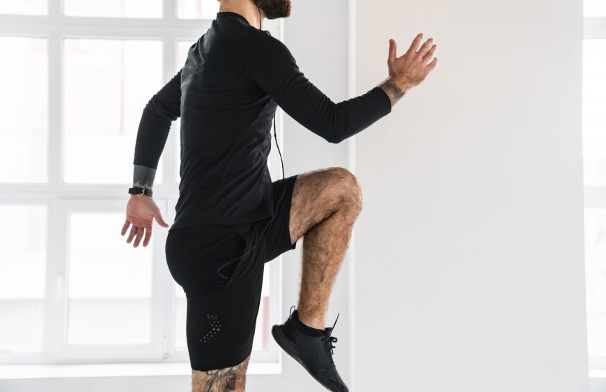Young brunette bearded white man in sportswear