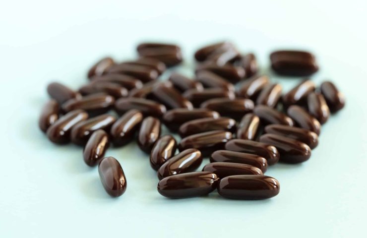 Medical pills and capsules. Brown medication on blue background. Pharmacy, healthcare, health insurance, medicine concept.