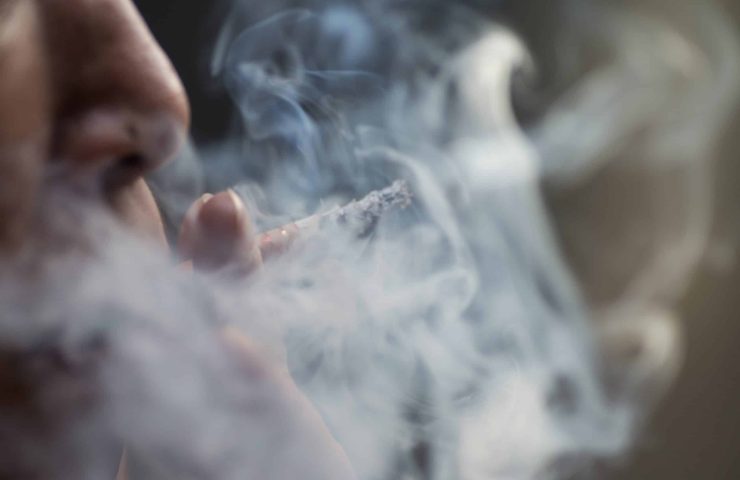 Selective focus shot of a female smoking cigarets – the concept of addiction