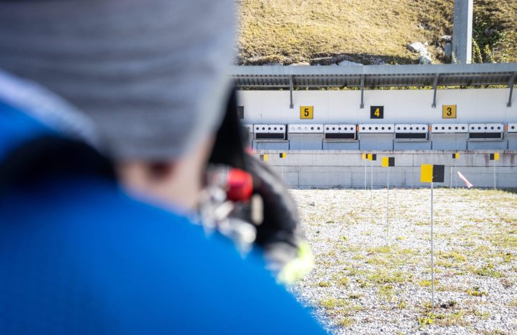 Sportsman playing biathlon and shooting