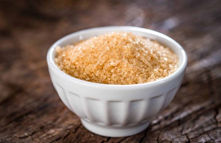 Brown sugar on wooden background