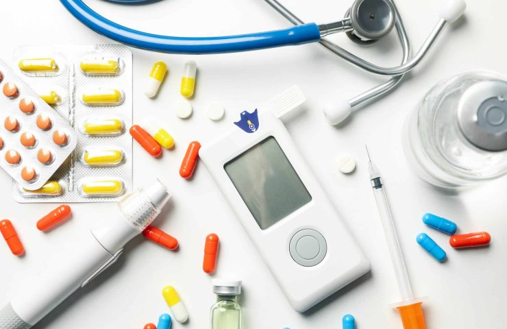 Diabetes accessories on white background, top view