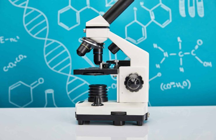 microscope on blue background with molecular structure
