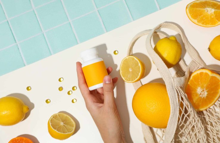 Bio-supplement vitamin C, in tablets on a light background.